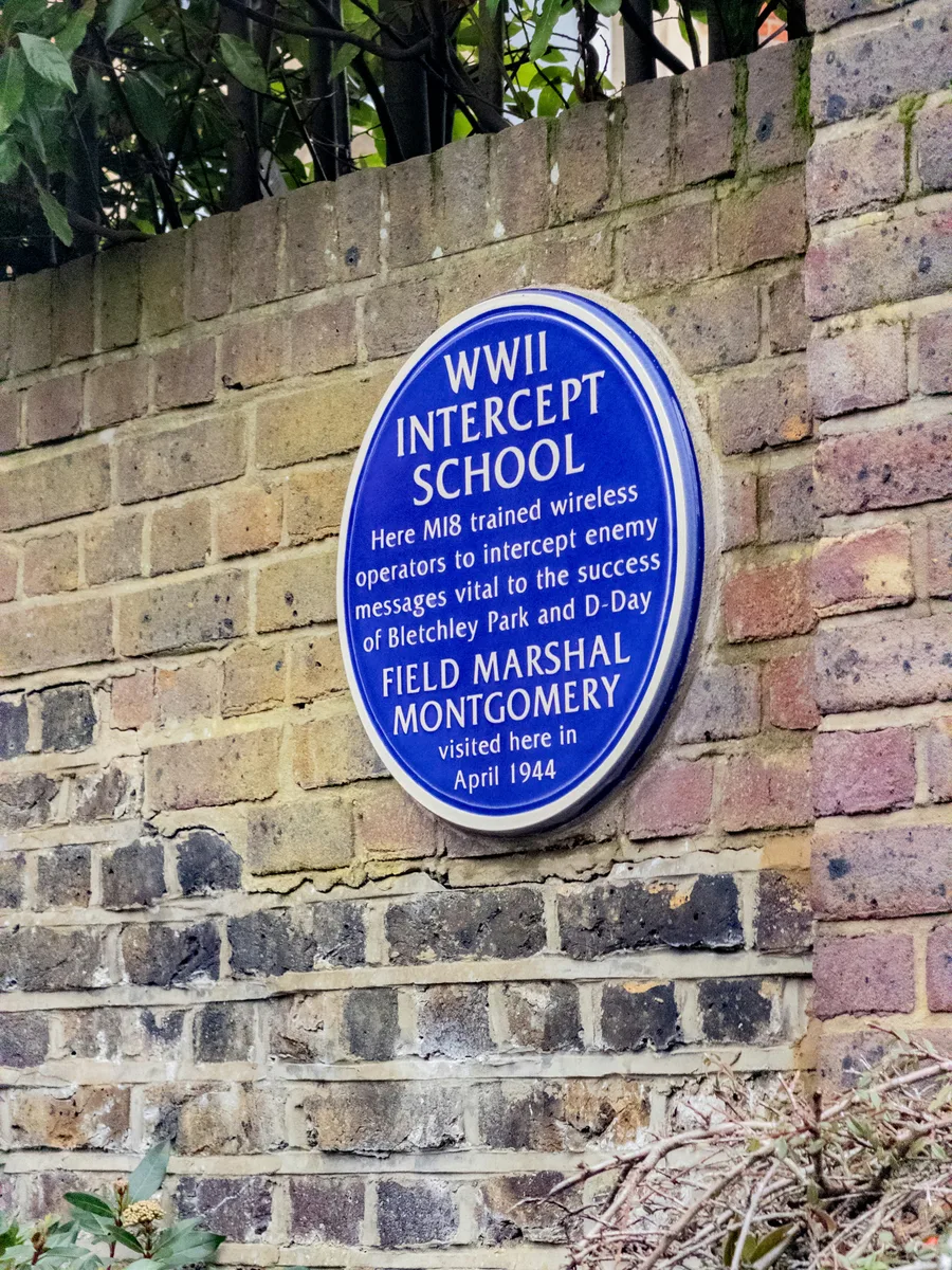 WWII intercept school heritage plaque on a brick wall in Hampstead, London