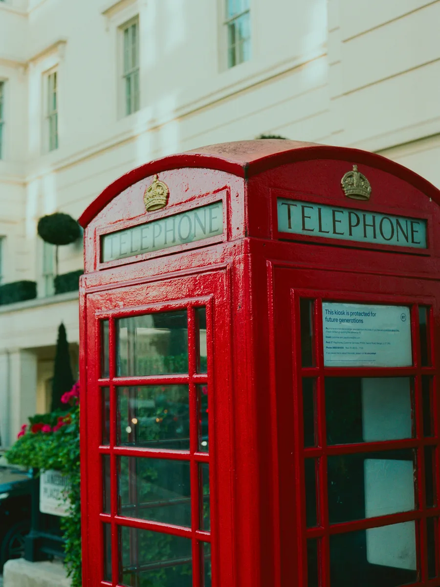 A classic red K6 telephone box on a Westminster street in London